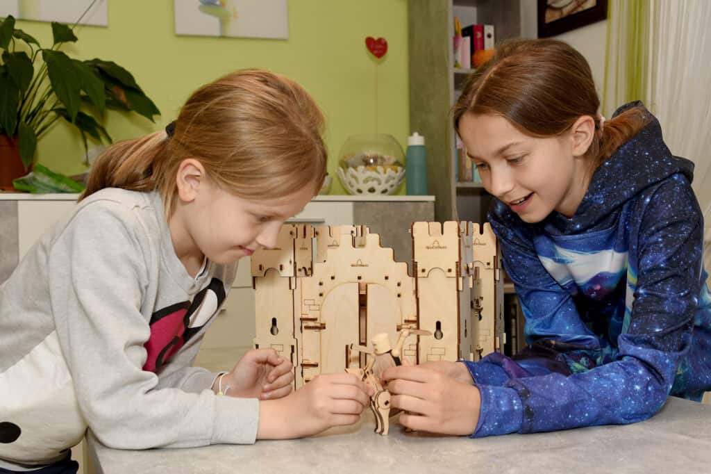 Children playing with wooden knight castle from the set castle guard - sustainable wooden toys from WoodHeroes